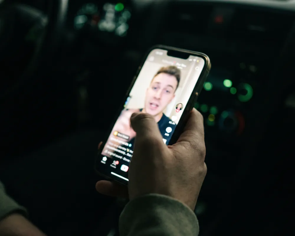 A phone playing a vertical short-form clip in a feed