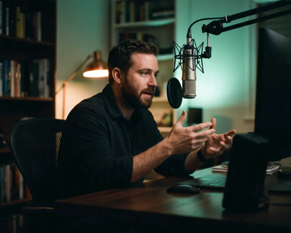 A founder talking to a microphone during a recorded session
